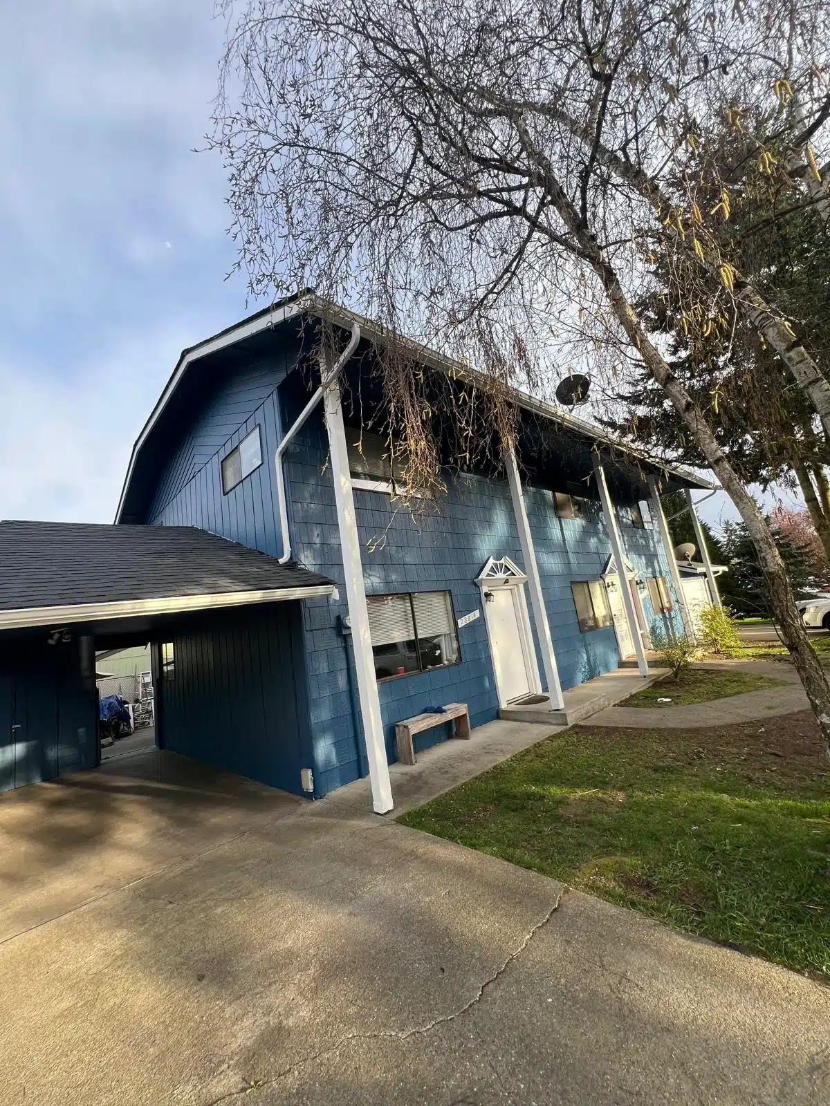 Blue Multi Family Building Exterior Painting A freshly painted blue multi family residential building with white trim and a carport, ready for new tenants.