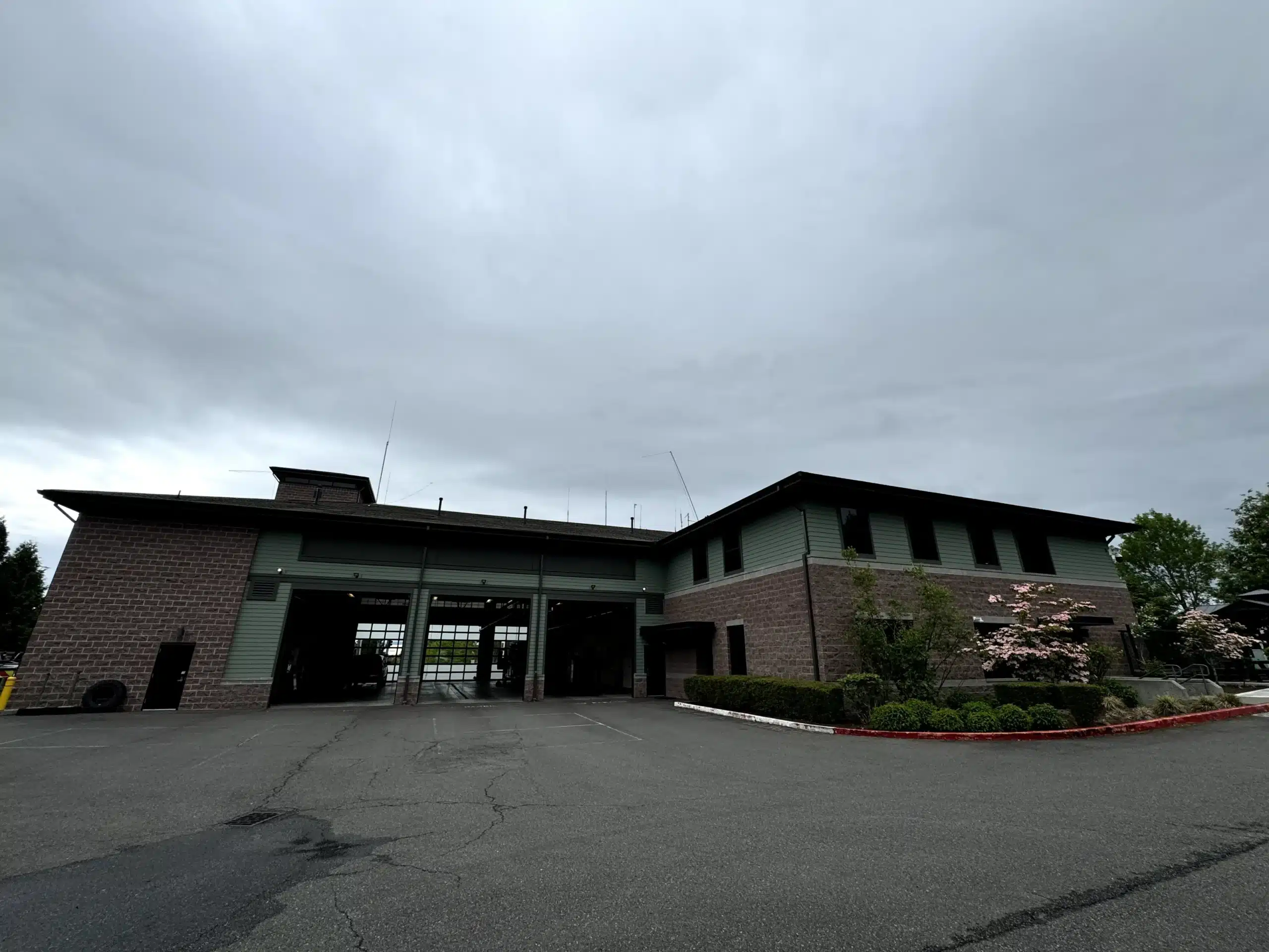 Fire Station Exterior Painting and Commercial Building Services Modern fire station exterior featuring brick and green siding, showcasing commercial painting expertise.